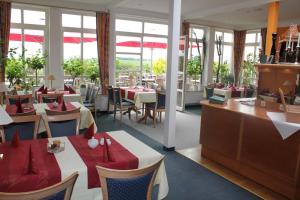a restaurant with tables and chairs with red napkins at Boutique Hotel & Restaurant Zum Kap Arkona in Putgarten