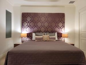 a bedroom with a large bed with a purple headboard at MacArthur Chambers in Brisbane +47 photos