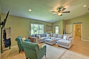 a living room with couches and a ceiling fan at Cozy Ranch Home with Patio on St Johns River! in Palatka