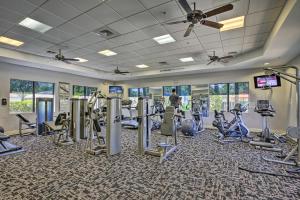 a gym with treadmills and elliptical machines at Bright and Airy Fort Myers Home with Pool Access! in Fort Myers Villas