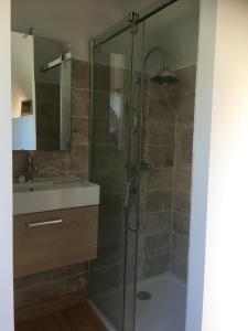 a bathroom with a shower with a sink and a tub at TY Fine Rose in Riec-sur-Bélon