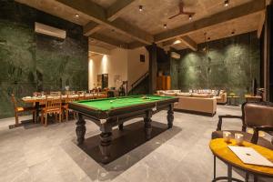 a room with a pool table in a restaurant at Sunset Boulevard by StayVista - Lakeside Villa with Pet-Friendly Ambiance, Deck, Terrace, Plunge Pool & Modern Flair in Karjat