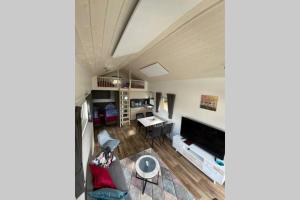 a living room with a large flat screen tv at Tiny House 1e in Varel