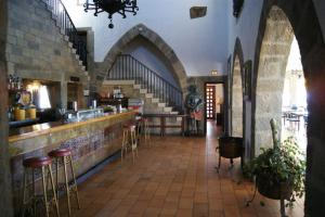 a restaurant with a bar and stools in a building at Hotel Temple Pradorrey in Astorga