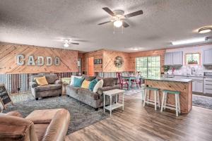 a large living room with a couch and a kitchen at Sues Camp with Caddo Lake Access and Dock! in Karnack