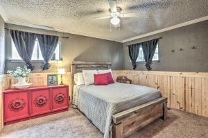 a bedroom with a bed and a ceiling fan at Sues Camp with Caddo Lake Access and Dock! in Karnack