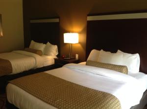 a hotel room with two beds and two lamps at Executive Inn and Suites Jefferson in Jefferson