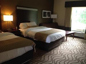 a hotel room with two beds and a window at Executive Inn and Suites Jefferson in Jefferson