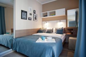 Habitación de hotel con cama y bandeja de comida en Apartament Luxon 2, en Kielce
