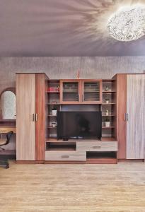 a large entertainment center with a flat screen tv at Apart-comfort Istanbul in Yaroslavl