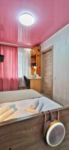 a bedroom with a large bed with a pink ceiling at Apart-comfort Istanbul in Yaroslavl