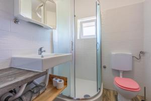 a bathroom with a sink and a toilet and a shower at Apartments Rozaria in Dramalj +50 photos