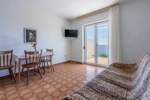 a living room with a table and a couch at Apartments Rozaria in Dramalj