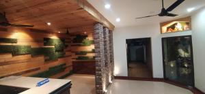 a living room with a brick wall and a ceiling at Hotel Samrat in Dehradun