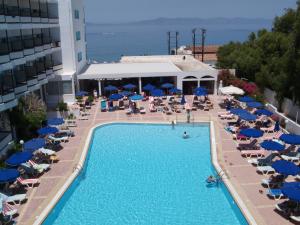 an overhead view of a hotel pool with chairs and umbrellas at Belair Beach Hotel in Ixia