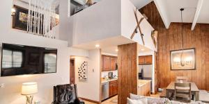 a living room and dining room with a kitchen and a dining table at Vantage Point #602 Condo in Vail