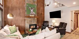 a living room with a white couch and a fireplace at Vantage Point #602 Condo in Vail