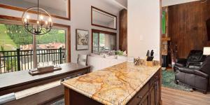 a kitchen and living room with a couch and a table at Vantage Point #602 Condo in Vail