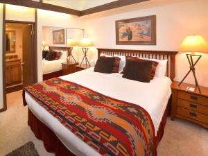 a hotel room with a large bed and a bedroom at Vantage Point 210 Condo in Vail