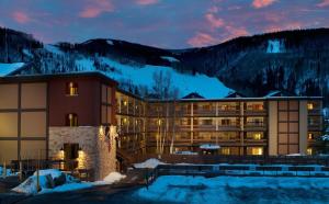 a hotel in the mountains at night in the snow at Wren 201 Condo with Vail Mountain View in Vail