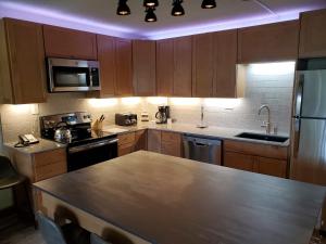 a kitchen with wooden cabinets and a counter top at Wren 201 Condo with Vail Mountain View in Vail