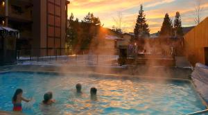 a group of people in a pool with a fountain at Wren 201 Condo with Vail Mountain View in Vail