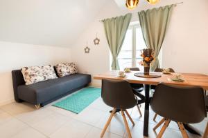a living room with a table and a couch at Apple tree apartment in Bled