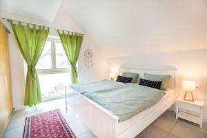 un letto bianco in una stanza con finestra di Apple tree apartment a Bled