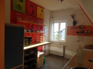 a kitchen with a counter with a microwave and a window at Haus Fink in Volkach
