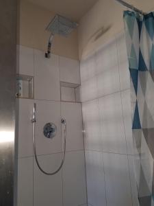 a shower with a glass door in a bathroom at Haus Fink in Volkach +11 photos