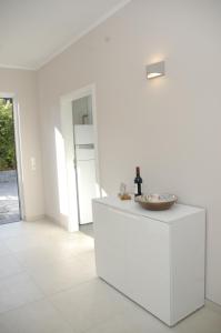 a white kitchen with a counter with a bowl on it at Ferienhaus Blick zum Rennsteig Etterwinden in Etterwinden +25 photos