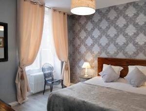 Un pat sau paturi într-o cameră la Hotel La Villa Marjane