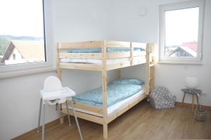 a bedroom with two bunk beds in a room at Ferienhaus Blick zum Rennsteig Etterwinden in Etterwinden