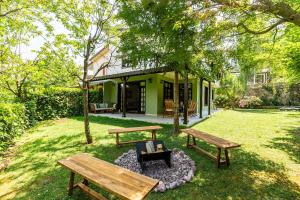 two picnic tables and a fire pit in a yard at Splendid Villa Surrounded by Nature in Sapanca in Sakarya