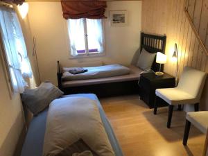 A bed or beds in a room at Charming Swiss Chalet Andermatt