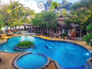 a pool at a resort with a dolphin in the water at Sand Sea Resort Railay Beach in Railay Beach