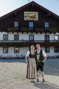 a man and a woman standing in front of a building at Keilhof in Seebruck
