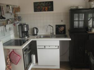 a small kitchen with a sink and a stove at Haus ReWi in Bünde