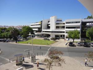 a large building with a parking lot in front of it at Original Apartments in Albufeira