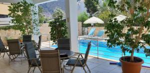 a patio with a table and chairs and a pool at Oase Apart in Kalkan