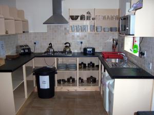 a kitchen with a stove top oven and a sink at Valley Lodge Farm Hostel in Claremorris