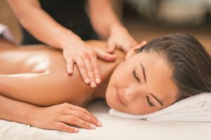a woman getting a massage from a therapist at Hard Rock Hotel Goa Calangute in Calangute