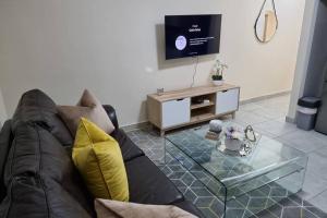 a living room with a couch and a glass table at Koena Court Apartment 3 - With Uncapped Fiber Wi-Fi in Midrand