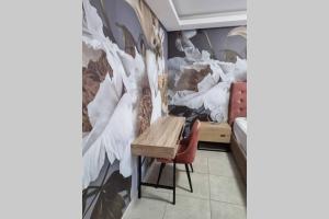 a room with a table and a white peacock mural at Koena Court Apartment 3 - With Uncapped Fiber Wi-Fi in Midrand