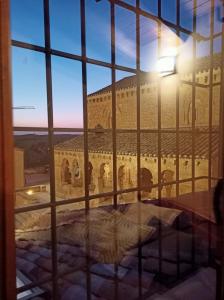 a view of a building through a window at Casa Rural El Mirador de San Miguel in San Esteban de Gormaz