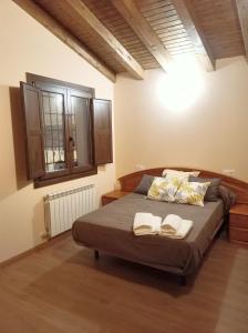 a bedroom with a bed with two books on it at Casa Rural El Mirador de San Miguel in San Esteban de Gormaz