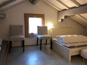 A bed or beds in a room at Charming Swiss Chalet Andermatt