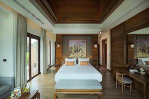 a bedroom with a large bed in a room at Thantara Resort Chiang Mai in Chiang Mai