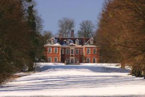 a large red brick house in the snow at Lainston House in Winchester