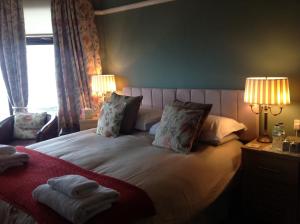 a bedroom with a bed with two lamps and a window at Yacht Bay View in Morecambe
